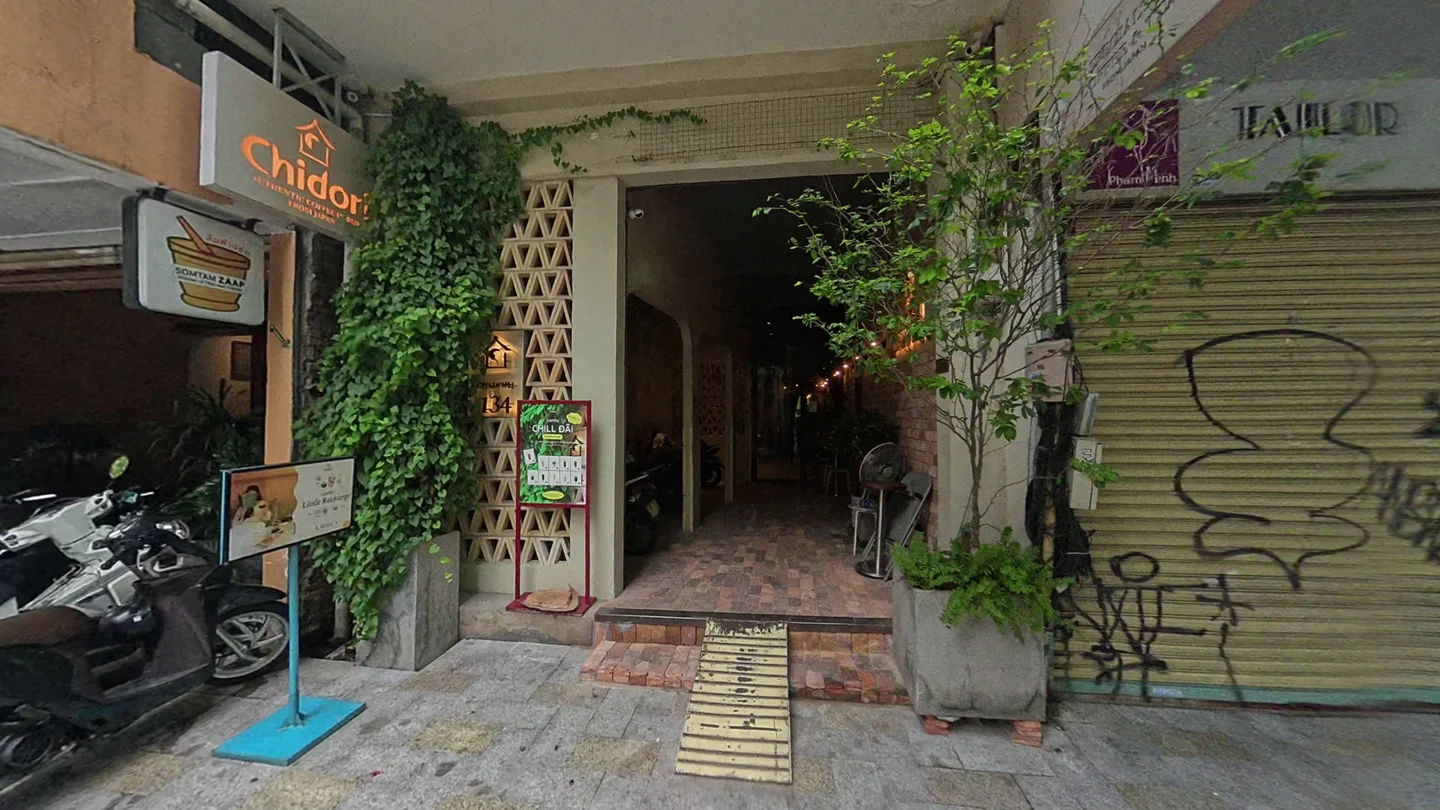 緑の植物に囲まれたChidori Coffee in Bedの入口